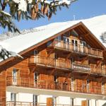 Slide Façade en bois de la résidence L’Ours Blanc aux 2 Alpes, au pied des pistes enneigées