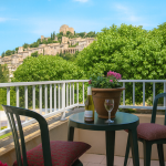 Slide Glass terrace at Le Hameau des Sources in Montbrun-les-Bains with a view of the village