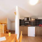 Slide Fully equipped kitchen area opening onto the living room of a duplex apartment in the Ours Blanc residence