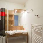 Slide Bathroom with bathtub and towel dryer in an apartment at the Résidence l'Ours Blanc in Les Deux Alpes