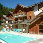 Slide Overview of La Combe d'Or residence in Les Orres 1800 under the sun with swimming pool