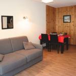Slide Stay in an apartment at La Combe d'Or residence in Les Orres 1800 with sofa and dining table