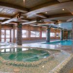Slide Photo of the heated indoor swimming pool, located in a beautiful wooden area in the Le Hameau de Beaufortain residence.