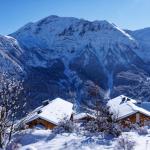 Slide Overall view from behind the Les Etoiles d'Orion residence with mountains covered in snow