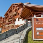 Slide Front view of the Les Chalets d’Émeraude residence in Les Saisies under the sun
