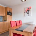 Slide Living area with dining table and open kitchen at the Les Chalets d’Émeraude residence