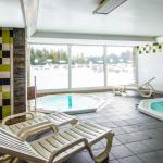 Slide Jacuzzi with lounge chairs within the Pyrénées 2000 residence