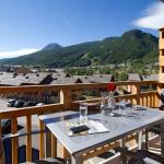 Slide Balcony with garden furniture and mountain view in summer at Serre Chevalier