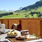 Slide Balcony with views of the sun-kissed mountains at Le Village de Lessy in Le Grand Bornand