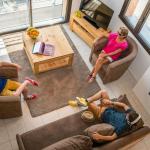 Slide Top view of a living room in an apartment at L’Écrin du Lac in Chorges