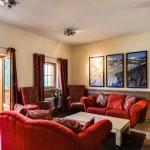 Slide Spacious lounge with red sofas and mountain view in Châtel