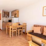 Slide Overview of the living area in an apartment at the Résidence Les Bottières with open kitchen connected to the living space