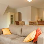 Slide Living room with sofa and dining area behind in a house at Le Clos des Oliviers residence