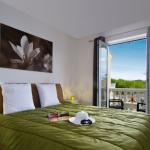 Slide Double bedroom with access to the balcony in a house at Le Clos des Oliviers residence