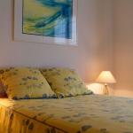 Slide Double bedroom with bedside tables and lamps in a house at Le Clos des Oliviers residence