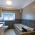 Slide Bathroom with bathtub and washbasin upstairs in a house at Le Clos des Oliviers residence