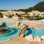 Slide Outdoor swimming pool with sun loungers and bridge over the water at Le Clos des Oliviers residence