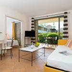 Slide Living room with terracotta floor tiles and view of the golf course from an accommodation unit at the Provence Country Club