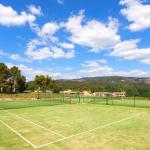 Slide Grass tennis court within the Provence Country Club residence