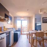 Slide Overview of the living room in a two-bedroom apartment at the Arya Living Stone residence