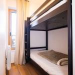 Slide Sleeping area with bunk beds in an apartment at the Arya Living Stone residence