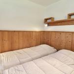 Slide Bedroom with two single beds, parquet flooring and a window overlooking the outside