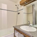 Slide Bathroom with bathtub and cabinet in an apartment in the Grands Bois residence in Courchevel La Tania