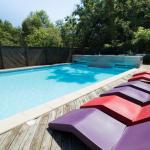 Slide Horizontal view of the heated swimming pool at Les Collines Iduki with sun loungers