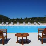 Slide Outdoor swimming pool with sun loungers and garden furniture at the Bourgeac estate near Les Beaux de Provence