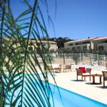 Slide View of the outdoor swimming pool with garden furniture and buildings in the background at the Bourgeac estate