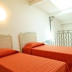 Slide Two single beds in a mezzanine at the Bourgeac estate