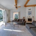 Slide Living room with fireplace opening onto the private terrace of a hamlet house at Domaine de Saint-Endréol Golf & Spa Resort in La Motte-en-Provence