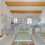 Slide Spacious living room with fireplace in an apartment opening onto a living space at Domaine de Saint-Endréol Golf & Spa Resort in La Motte-en-Provence