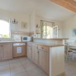 Slide Functional, fully equipped kitchen open to the living area in a typical apartment at Domaine de Saint-Endréol Golf & Spa Resort in La Motte-en-Provence