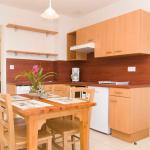 Slide Equipped open kitchen with dining area in an apartment at La Marquisié