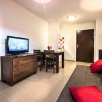Slide Lounge with sofa bed and television in an apartment at Résidence Le Clos du Rocher in Dordogne