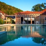 Slide Outdoor pool at Résidence Le Clos du Rocher at the end of the day