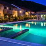 Slide Pool at Résidence Le Clos du Rocher in Dordogne illuminated at night