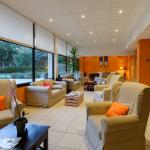 Slide Lounge area with sofas at the reception of Résidence Les Roches Douvres