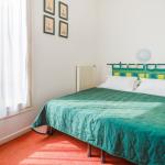 Slide Bedroom with a double bed and bedside table in an apartment at Résidence du Golf