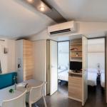 Slide Large, open, air-conditioned living room in a mobile home at Camping del Mar 4* in Malgrat de Mar