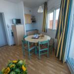 Slide Living area of a sea-view studio at the Eugénie residence in Biarritz, with dining area and access to an outdoor balcony