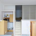 Slide Full living space of a studio for four people at the Eugénie residence in Biarritz, featuring a mezzanine