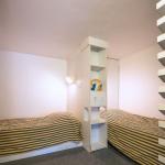 Slide Two single beds in the mezzanine of a four-person studio at the Eugénie residence in Biarritz