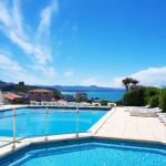 Slide View of the two outdoor pool areas at the Eugénie residence in Biarritz, with sun loungers and sea views