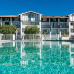 Slide View of the outdoor pool and the Ilbarritz residence in Bidart under a blue sky