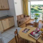 Slide Open-plan living room with dining area in an apartment at the Ilbarritz residence in Bidart