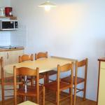 Slide Dining area with open kitchen in an apartment at the Ilbarritz residence in Bidart