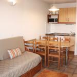 Slide Living room of an apartment at the Soko Eder residence with sofa bed and dining area