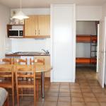 Slide Living area with dining space and a glimpse of the sleeping area in a Soko Eder apartment